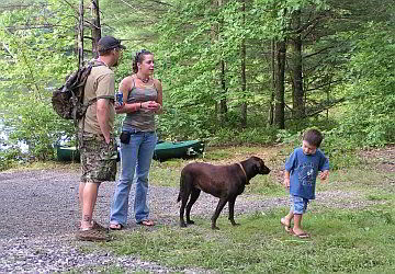 boy leading dog on hike